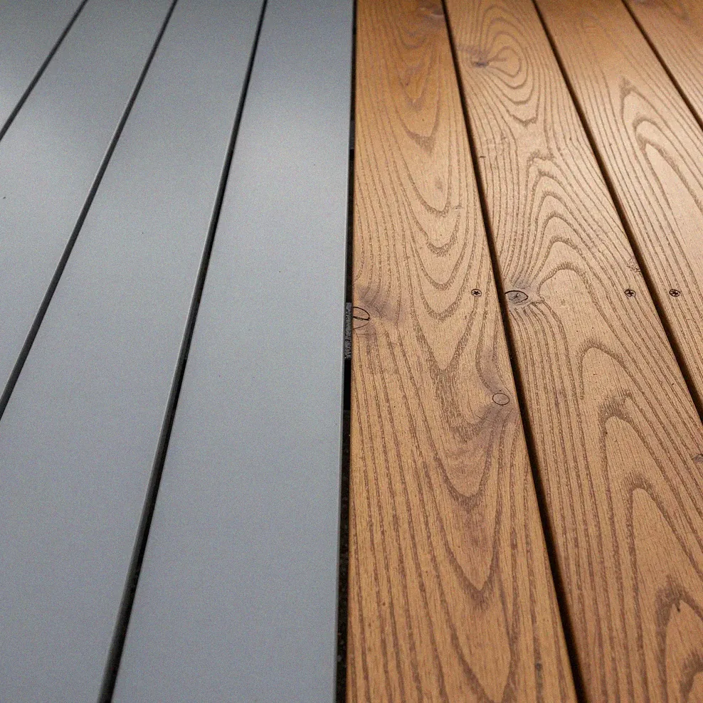 Two sections of the same deck: one with solid paint, the other with semi-transparent stain